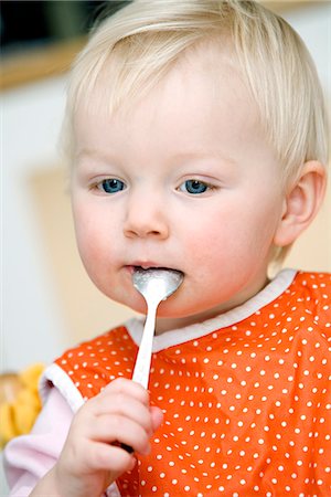 Blond baby girl eating, Sweden. Stock Photo - Premium Royalty-Free, Code: 6102-03867777
