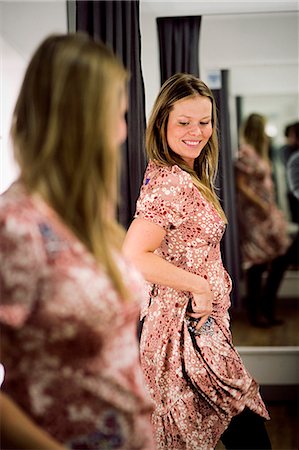 simsearch:6102-03750219,k - Woman trying clothes in a fitting room, Stockholm, Sweden. Foto de stock - Sin royalties Premium, Código: 6102-03826863