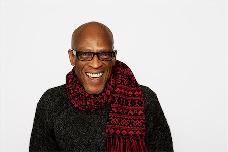 Portrait of a smiling man wearing a scarf. Stock Photo - Premium Royalty-Free, Code: 6102-03826806