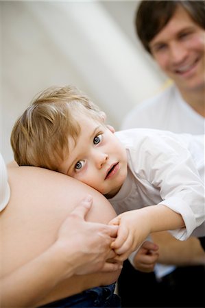 A small child listening to a pregnant woman's stomach, Sweden. Stock Photo - Premium Royalty-Free, Code: 6102-03826975