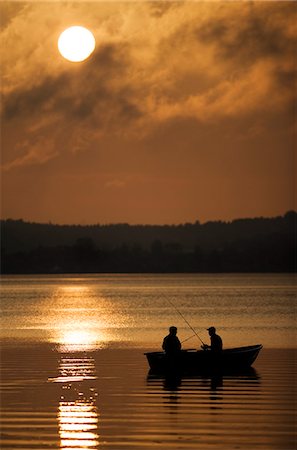 friends fishing on boat - Two persons sitting in a boat fishing at night, Mariefred, Sweden. Stock Photo - Premium Royalty-Free, Code: 6102-03827077