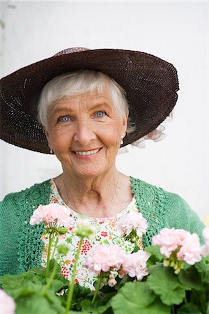 Old scandinavian woman  with pelargonium, Sweden. Stock Photo - Premium Royalty-Free, Code: 6102-03827007