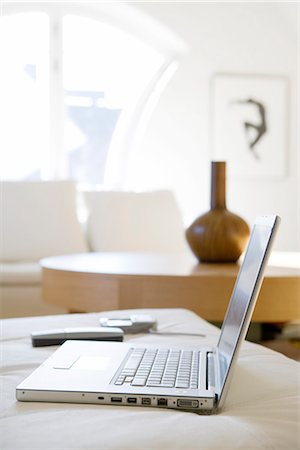 A laptop on a sofa. Stock Photo - Premium Royalty-Free, Code: 6102-03827183