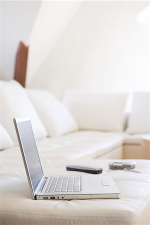 A laptop on a sofa. Stock Photo - Premium Royalty-Free, Code: 6102-03827182