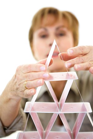 Woman building a house of cards. Foto de stock - Royalty Free Premium, Número: 6102-03827200