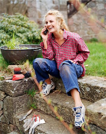 simsearch:6102-03828834,k - A woman sitting in a garden talking in a cellphone, Sweden. Stock Photo - Premium Royalty-Free, Code: 6102-03827506