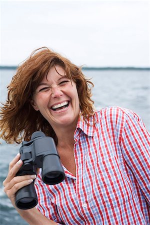 simsearch:6102-03750096,k - A woman on a boat a sunny summer''s day, the archipelago of Stockholm, Sweden. Stock Photo - Premium Royalty-Free, Code: 6102-03827532