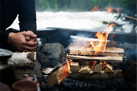 fire in hands - A man sitting by a camp fire, Sweden. Foto de stock - Sin royalties Premium, Código: 6102-03827682