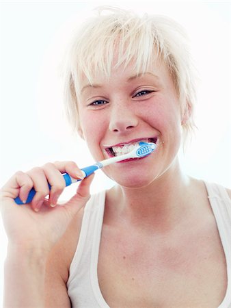 simsearch:6102-08270959,k - A Scandinavian teenage girl brushing her teeth. Stock Photo - Premium Royalty-Free, Code: 6102-03827779