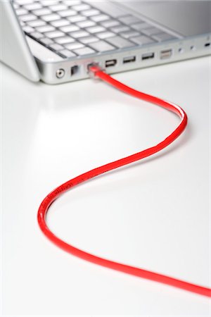 electrical cord - A computer with an internet cable, close-up. Stock Photo - Premium Royalty-Free, Code: 6102-03827800