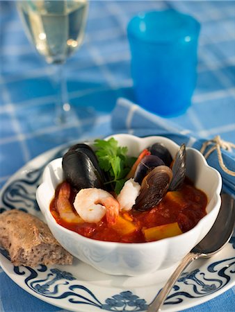 simsearch:6102-08800567,k - Seafood stew with bread and a glass of wine, Sweden. Stock Photo - Premium Royalty-Free, Code: 6102-03827982