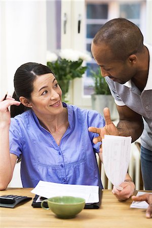 simsearch:6102-04929446,k - A woman and a man paying bills. Stock Photo - Premium Royalty-Free, Code: 6102-03827913