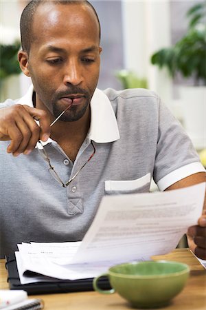 simsearch:6102-04929446,k - A man paying the bills, Sweden. Stock Photo - Premium Royalty-Free, Code: 6102-03827915