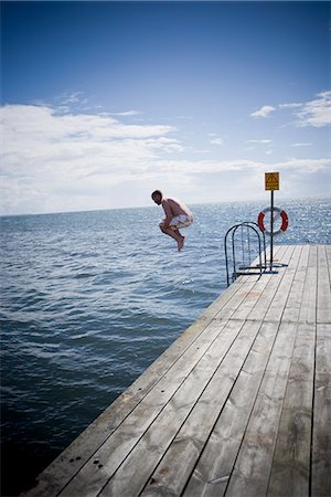 dock jumping - A man going for a swim, Skane, Sweden. Stock Photo - Premium Royalty-Free, Code: 6102-03828360