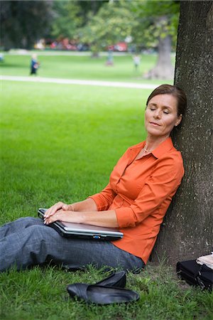 simsearch:6102-03828834,k - A woman resting in a park, Sweden. Stock Photo - Premium Royalty-Free, Code: 6102-03828444