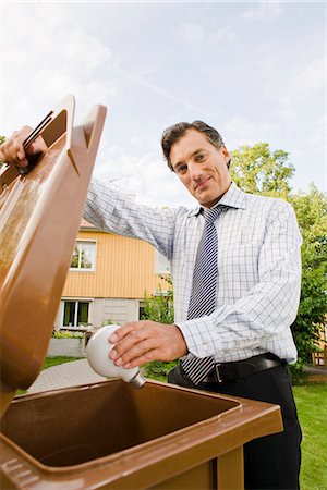 A man recycling a light bulb, Sweden. Stock Photo - Premium Royalty-Free, Code: 6102-03828479