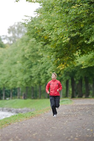 A woman jogging in a park, Sweden. Stock Photo - Premium Royalty-Free, Code: 6102-03828492