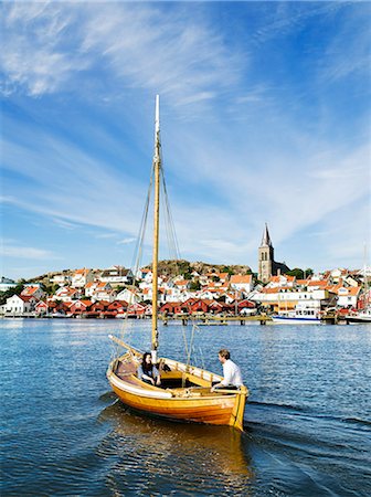 small boat - Tree boat in front of a coastal town, Sweden. Stock Photo - Premium Royalty-Free, Code: 6102-03828406