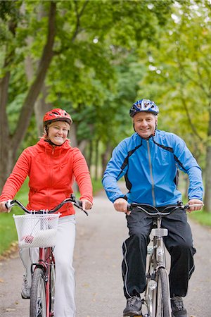 A couple cykling in a park, Sweden. Stock Photo - Premium Royalty-Free, Code: 6102-03828500