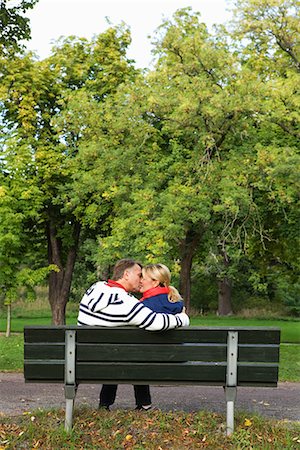 A couple sitting on a bench in the park, Sweden. Stock Photo - Premium Royalty-Free, Code: 6102-03828536