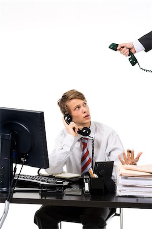 A teenage boy as a businessman at the office. Stock Photo - Premium Royalty-Free, Code: 6102-03828771