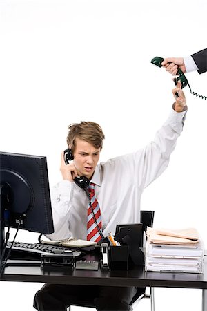 A teenage boy as a businessman at the office. Stock Photo - Premium Royalty-Free, Code: 6102-03828772