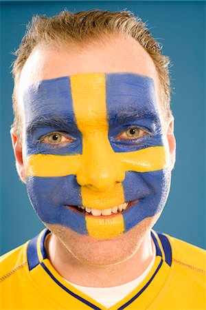 simsearch:6102-03905685,k - A man with the Swedish flag painted in his face. Stock Photo - Premium Royalty-Free, Code: 6102-03828842