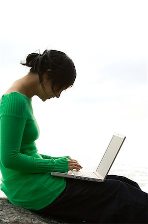 simsearch:6102-03828834,k - A young woman on a rock using a laptop, Sweden. Stock Photo - Premium Royalty-Free, Code: 6102-03828828
