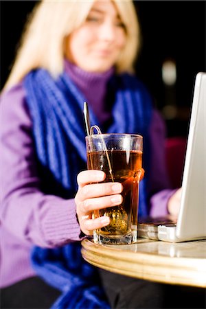 simsearch:6102-07843687,k - Young woman sitting in a cafe using a laptop, Sweden. Stock Photo - Premium Royalty-Free, Code: 6102-03828963