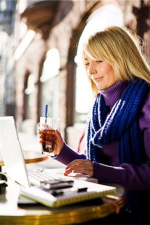 Young woman sitting in a cafe using a laptop, Sweden. Stock Photo - Premium Royalty-Free, Code: 6102-03828960