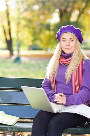 simsearch:6102-03828834,k - A woman sitting on bench in a park using a laptop, Stockholm, Sweden. Stock Photo - Premium Royalty-Free, Code: 6102-03828984