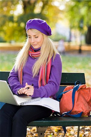 simsearch:6102-03828834,k - A woman sitting on bench in a park using a laptop, Stockholm, Sweden. Stock Photo - Premium Royalty-Free, Code: 6102-03828985