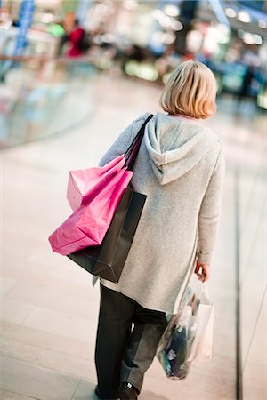 senior woman alone from behind - A woman carrying shopping bags, Stockholm, Sweden. Stock Photo - Premium Royalty-Free, Code: 6102-03829149