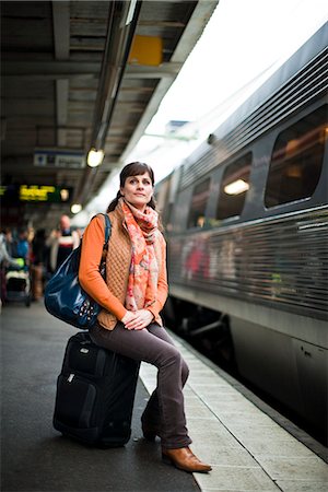 people waiting for train - A woman at a railway station, Sweden. Stock Photo - Premium Royalty-Free, Code: 6102-03829113