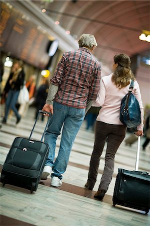 suitcase walking away - A couple with suitcases at a railway station, Sweden. Stock Photo - Premium Royalty-Free, Code: 6102-03829127