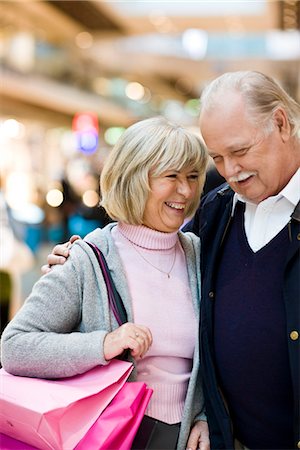 Senior couple carrying shopping bags, Stockholm, Sweden. Stock Photo - Premium Royalty-Free, Code: 6102-03829138