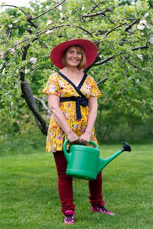 simsearch:6102-07769055,k - Portrait of a woman in a garden, Sweden. Stock Photo - Premium Royalty-Free, Code: 6102-03959798