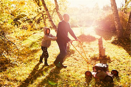 A father with his daughter in the garden, Sweden. Stock Photo - Premium Royalty-Free, Code: 6102-03903951