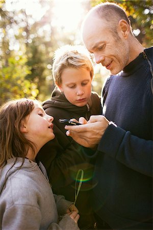 Man and two children in the forest, Sweden. Stock Photo - Premium Royalty-Free, Code: 6102-03903956