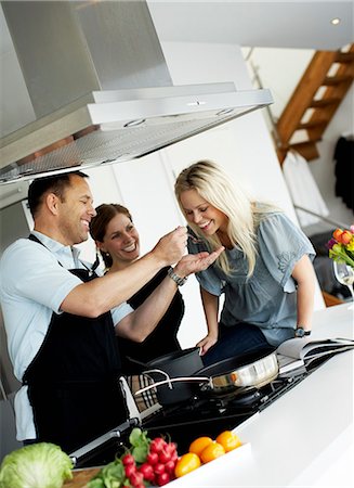 friends cooking together - Woman tasting dinner, Sweden. Stock Photo - Premium Royalty-Free, Code: 6102-03904072