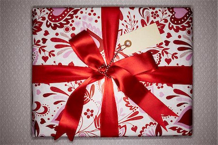 silky - A Christmas present with red silk ribbons wrapped around it, Denmark. Stock Photo - Premium Royalty-Free, Code: 6102-03904253