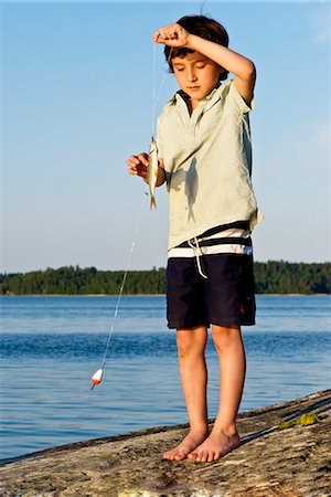 simsearch:6102-03867416,k - A boy with a roach, Sweden. Stock Photo - Premium Royalty-Free, Code: 6102-03904386