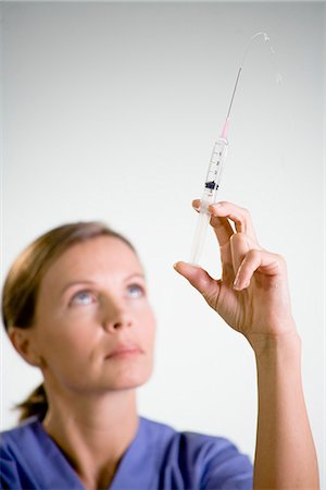 female nurse inject woman - Nurse preparing injection, close-up. Stock Photo - Premium Royalty-Free, Code: 6102-03904301