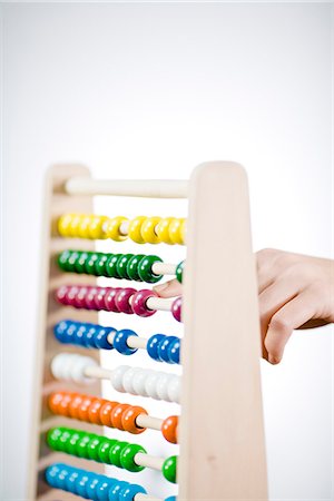 educational toys - A woman using an abacus. Stock Photo - Premium Royalty-Free, Code: 6102-03904447