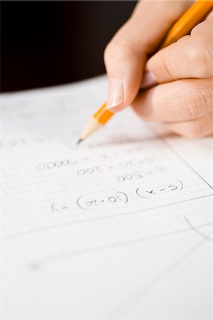 pencils and pens - A woman working out a sum, close-up. Stock Photo - Premium Royalty-Free, Code: 6102-03904451
