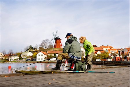 social adult activities - Grandfather and grandson fishing, Sodermanland, Sweden. Stock Photo - Premium Royalty-Free, Code: 6102-03904407