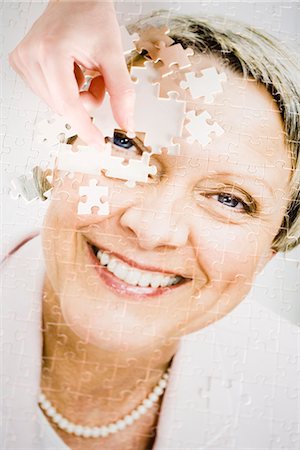 A puzzle with the image of a woman. Stock Photo - Premium Royalty-Free, Code: 6102-03904427