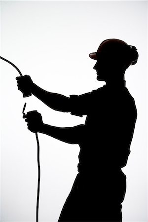 divided - A construction worker with an electric cable. Foto de stock - Sin royalties Premium, Código: 6102-03904554