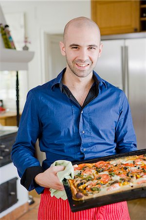 simsearch:6102-06777551,k - Man with a homemade pizza, Sweden. Stock Photo - Premium Royalty-Free, Code: 6102-03904785