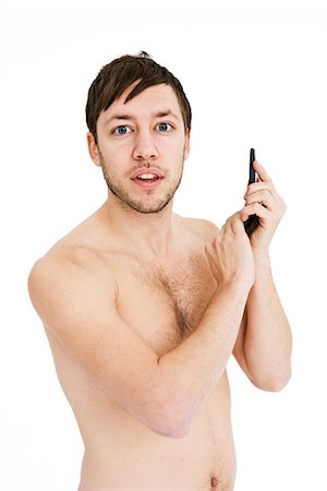Young man using his mobile phone. Stock Photo - Premium Royalty-Free, Code: 6102-03904849